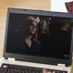 A man watches Emily Deschanel in 'Bones' on a laptop.